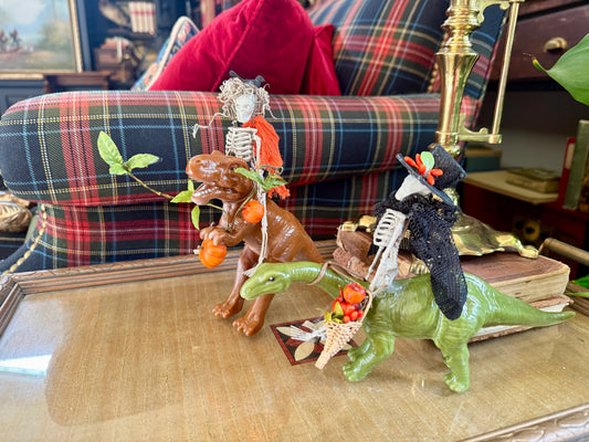 Set of Two Skeletons Riding Dinos